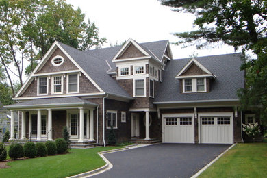 Example of a classic brown three-story wood exterior home design in New York
