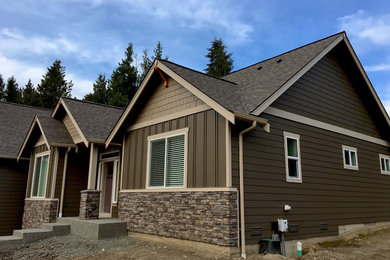 Imagen de fachada de casa multicolor de estilo americano de tamaño medio de dos plantas con revestimientos combinados, tejado a dos aguas y tejado de teja de barro