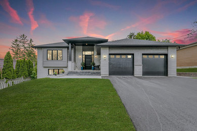 Inspiration for a mid-sized modern gray house exterior remodel in Other with a shingle roof