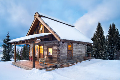 Example of a mountain style brown one-story wood gable roof design in Other with a shingle roof