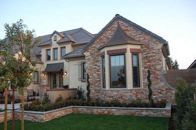 Inspiration for a large timeless one-story mixed siding exterior home remodel in Other