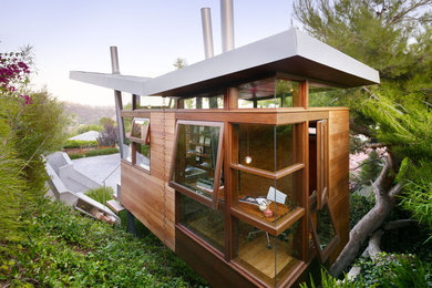 Inspiration for a modern wood exterior home remodel in Los Angeles with a butterfly roof