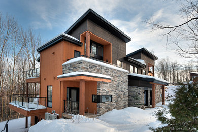 Design ideas for a large contemporary house exterior in Montreal with three floors.