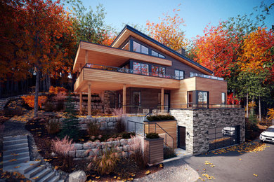 Trendy gray three-story wood exterior home photo in Montreal