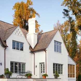 Traditional white two-story brick exterior home idea in Raleigh