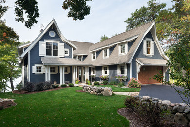 Inspiration for a large and blue classic detached house in Minneapolis with three floors, wood cladding, a pitched roof and a shingle roof.