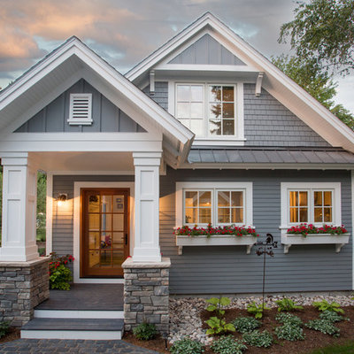 Gray two-story concrete fiberboard house exterior photo in Other with a mixed material roof