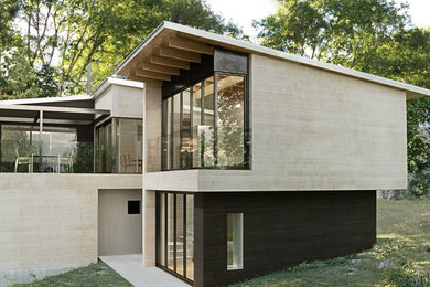 Diseño de fachada actual de tamaño medio de dos plantas con revestimiento de madera y tejado de un solo tendido