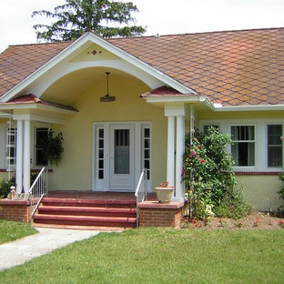 Cottage House with a Stucco Exterior Painted Yellow in Tuckahoe, NJ