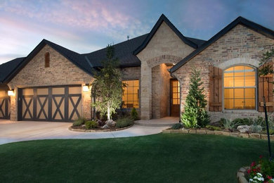 Transitional beige one-story brick house exterior photo in Oklahoma City with a hip roof and a shingle roof