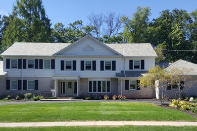 Large transitional two-story mixed siding gable roof photo in Cleveland