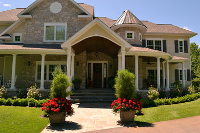 Example of a classic beige two-story mixed siding exterior home design in Other