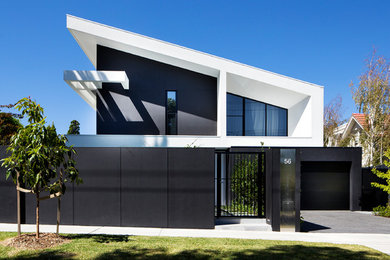 This is an example of a black contemporary two floor detached house in Melbourne with a lean-to roof.
