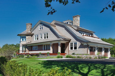 Example of a huge beach style gray three-story wood house exterior design in Other with a gambrel roof and a shingle roof