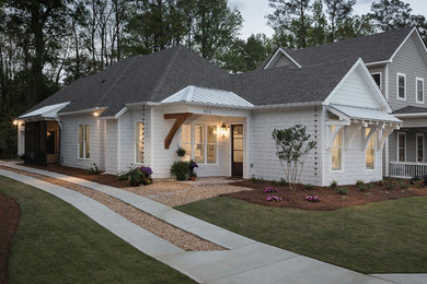 Small cottage white one-story concrete house exterior idea in Atlanta with a mixed material roof