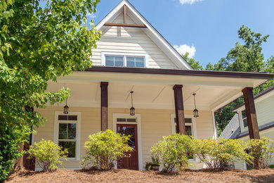 Example of a mid-sized arts and crafts beige two-story concrete gable roof design in Atlanta