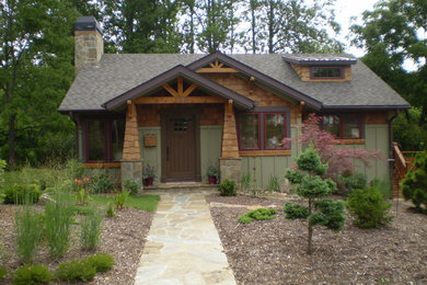 Example of a mid-sized arts and crafts two-story mixed siding exterior home design in Other