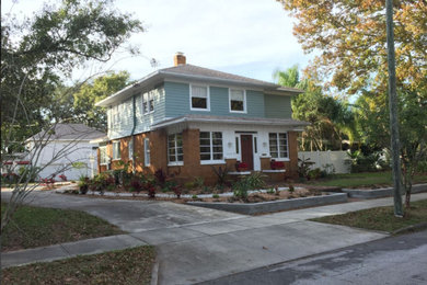 Example of a large arts and crafts blue two-story mixed siding house exterior design in Tampa with a clipped gable roof