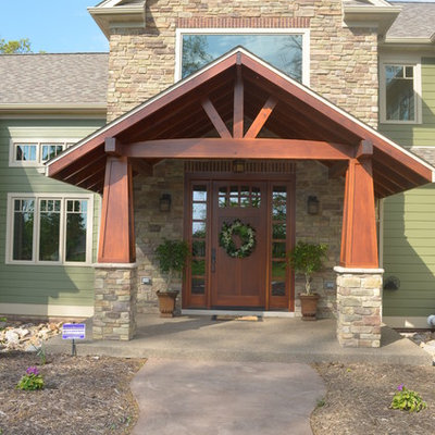 Example of an arts and crafts green exterior home design in Other