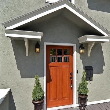 Craftsman Front Door With Portico And Urns With Topiaries