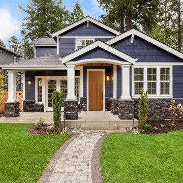 Craftsman Home with Columns and a Wood Front Door