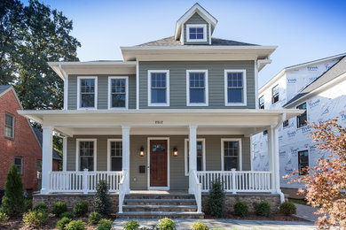 Craftsman green three-story concrete fiberboard house exterior idea in DC Metro with a shingle roof