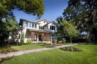 Example of an arts and crafts two-story stucco exterior home design in Orlando