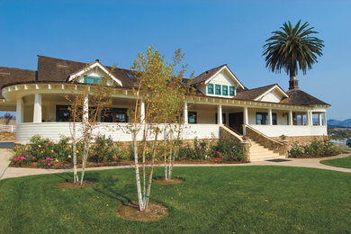 Example of a large cottage two-story wood exterior home design in San Luis Obispo