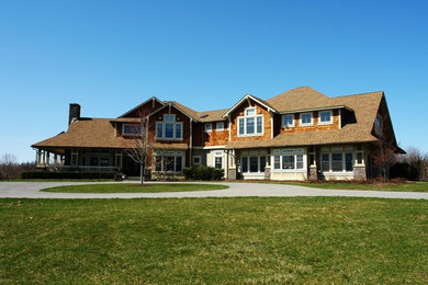 Inspiration for a large craftsman brown two-story mixed siding exterior home remodel in New York with a clipped gable roof