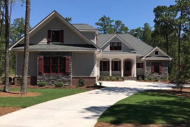 Mid-sized craftsman gray two-story vinyl house exterior idea in Raleigh with a hip roof and a shingle roof
