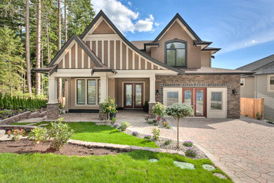 Example of a large classic brown three-story house exterior design in Vancouver