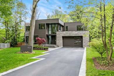 Inspiration for a large contemporary gray two-story wood exterior home remodel in Toronto