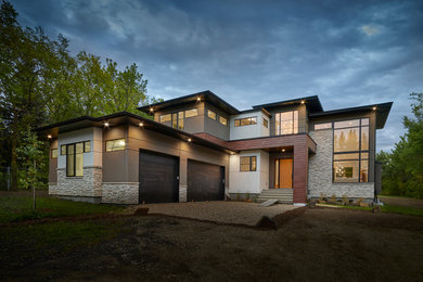 Example of a mid-sized minimalist two-story mixed siding house exterior design in Edmonton