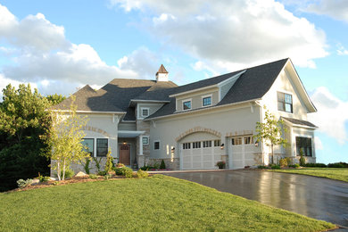 Example of a large classic white two-story stucco exterior home design in Minneapolis
