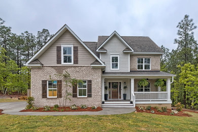 Mid-sized minimalist gray two-story brick exterior home photo in Other with a shingle roof