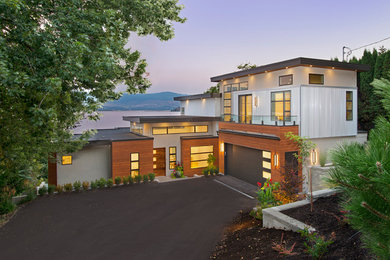 Inspiration for a contemporary detached house in Vancouver with mixed cladding and a flat roof.