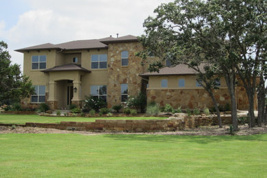Inspiration for a large mediterranean brown two-story stucco gable roof remodel in Austin