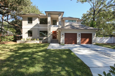 Example of a mid-sized trendy two-story mixed siding house exterior design in Tampa with a hip roof and a shingle roof