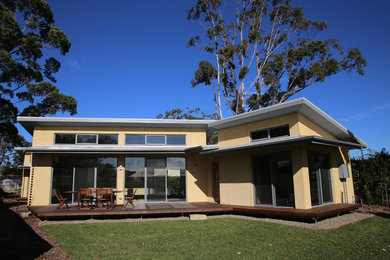 Photo of a medium sized and yellow contemporary bungalow house exterior in Wollongong.
