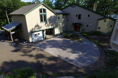 Example of a large arts and crafts adobe exterior home design in Portland Maine