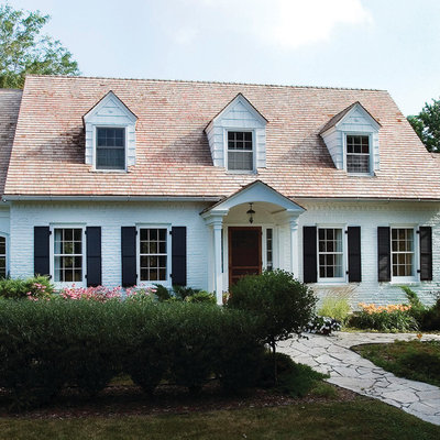 Example of a classic two-story brick gable roof design in Minneapolis