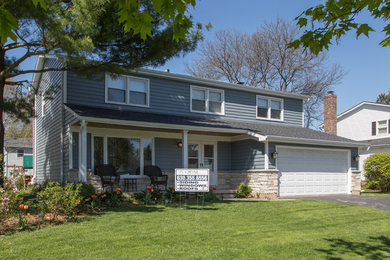 Example of a mid-sized classic blue two-story concrete fiberboard exterior home design in Chicago with a shingle roof