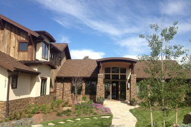 Inspiration for a rustic stone exterior home remodel in Denver