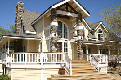 Example of a mid-sized classic beige two-story concrete fiberboard gable roof design in San Luis Obispo