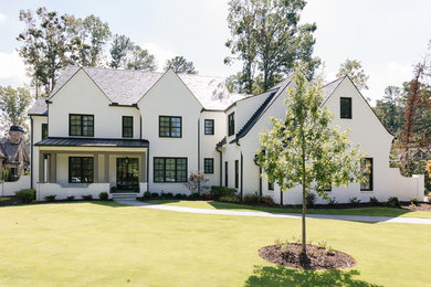 Foto de fachada de casa blanca clásica renovada de tamaño medio de tres plantas con revestimiento de ladrillo, tejado a dos aguas y tejado de varios materiales