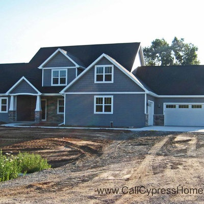 Mid-sized traditional gray two-story vinyl exterior home idea in Other