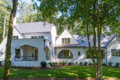 Huge transitional white two-story painted brick exterior home idea in Atlanta with a tile roof