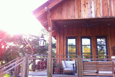 Inspiration for a farmhouse house exterior in Austin with wood cladding.