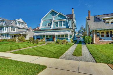 Coastal blue three-story house exterior idea in New York with a gambrel roof