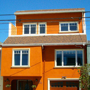 Design ideas for a mid-sized transitional three-storey stucco orange exterior in San Francisco.